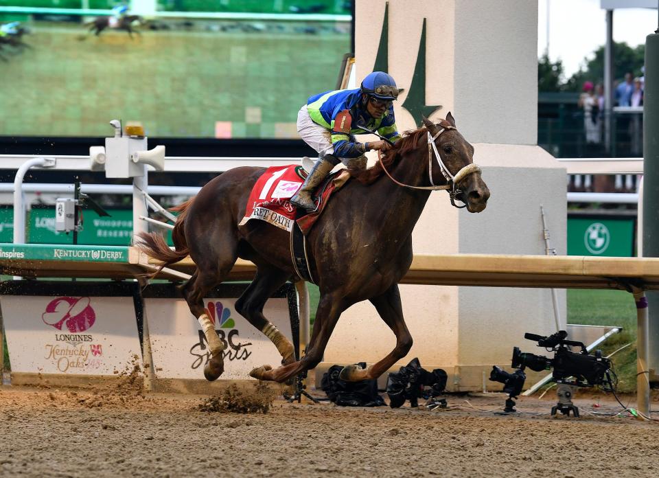 Secret Oath with jockey Luis Saez up crosses the finish line to win the 148th running of the Kentucky Oaks, Friday, May 6 2022 in Louisville Ky.
