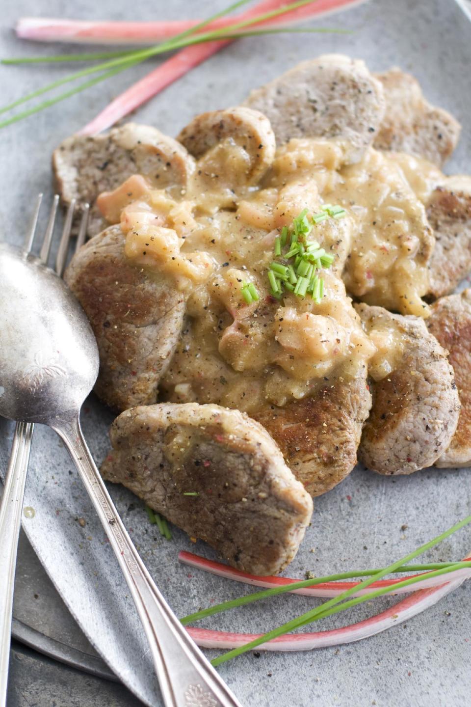 In this image taken on March 18, 2013, pork tenderloin medallions with rhubarb-orange sauce are shown served on a plate in Concord, N.H. (AP Photo/Matthew Mead)