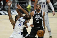 Los Angeles Clippers forward Kawhi Leonard (2) fouls Dallas Mavericks forward Tim Hardaway Jr. (11) during the third quarter of Game 7 of an NBA basketball first-round playoff series Sunday, June 6, 2021, in Los Angeles, Calif. (AP Photo/Ashley Landis)