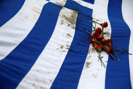 Athens' Polytechnic school students carry a blood-stained Greek flag during a rally marking the 45th anniversary of a 1973 student uprising against the military dictatorship that was ruling Greece, in Athens, Greece, November 17, 2018. REUTERS/Costas Baltas