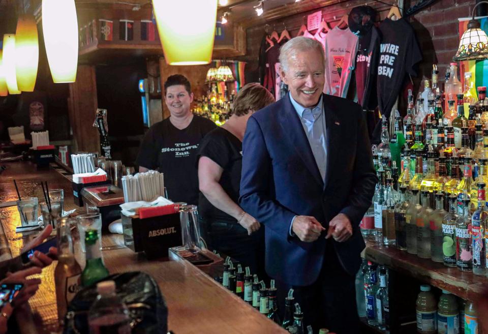 Former Vice President and 2020 Democratic presidential candidate Joe Biden, right, joins bartenders behind the counter during his visit to the Stonewall Inn, Tuesday, June 18, 2019, in New York. Biden paid a visit to the Stonewall Inn ahead of the 50th anniversary of an uprising that helped spark the gay rights movement.