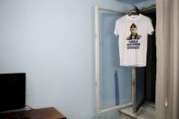 A t-shirt with a picture of Russian President Vladimir Putin and which reads "The most polite President" is seen in this photo illustration taken in a hotel room in Kazan, Russia, August 2, 2015. REUTERS/Stefan Wermuth