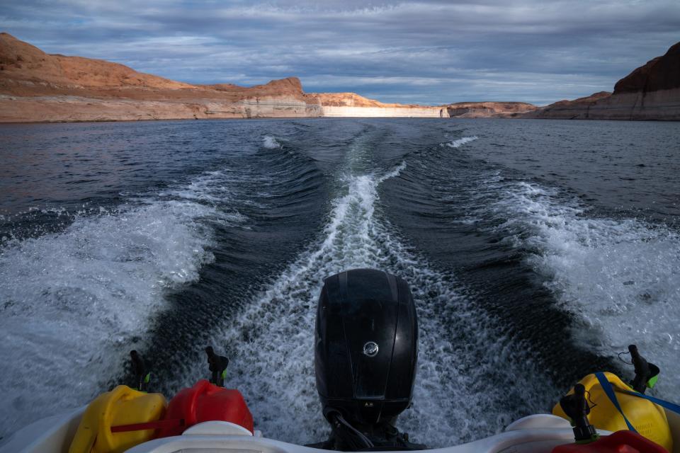 A boat cruises on Lake Powell near Bullfrog Marina on Aug. 15, 2022. Boat ramps have had to be extended multiple times as water levels receded at Lake Powell.