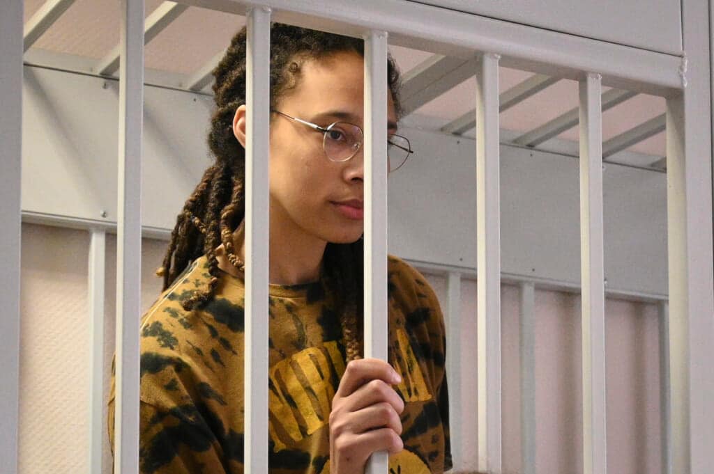 WNBA star and two-time Olympic gold medalist Brittney Griner stands in a cage in a courtroom prior to a hearing in the Khimki district court, just outside Moscow, Russia, Friday, July 15, 2022. (AP Photo/Dmitry Serebryakov)