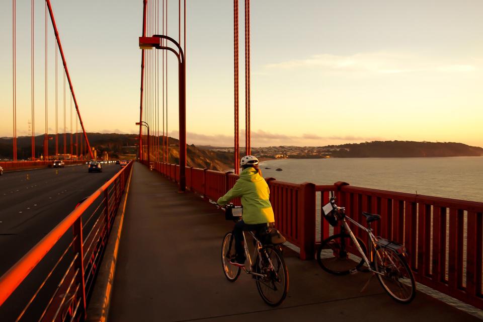 Woman Cycling Over Golden Gate