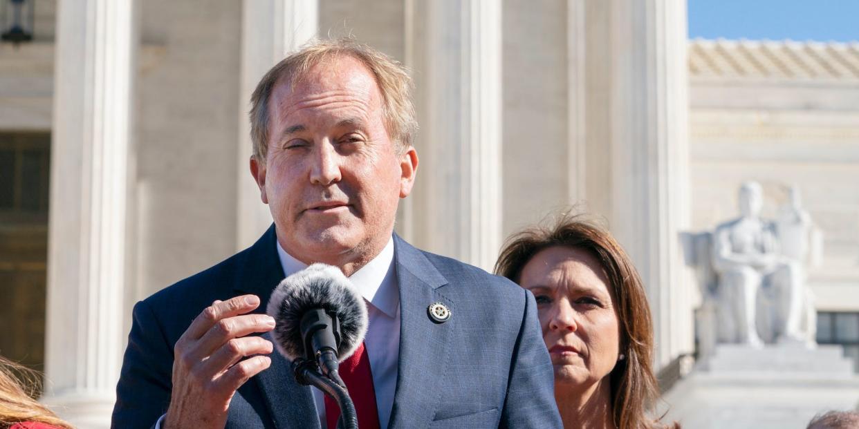 Texas Attorney General Ken Paxton, left, next to his wife and Texas State Sen. Angela Paxton, speaks to anti-abortion activists at a rally outside the Supreme Court, Monday, Nov. 1, 2021