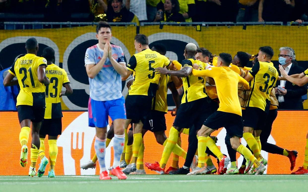 BSC Young Boys' Jordan Siebatcheu celebrates scoring their second goal with teammates as Manchester United's Harry Maguire looks dejected. - REUTERS