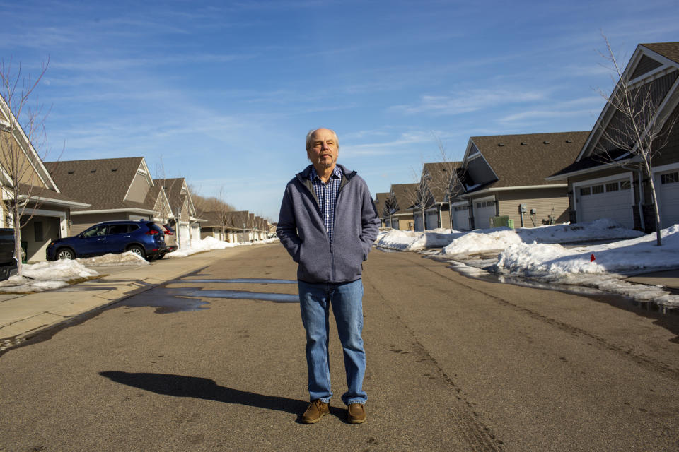 Jeffrey Carlson stands for a portrait outside his home in Vadnais Heights, Minn., on Sunday, March 13, 2022. Carlson, a Type 1 diabetic with heart stents, contracted COVID-19 in January, but recovered quickly after being treated with Merck's molnupiravir medication. (AP Photo/Nicole Neri)