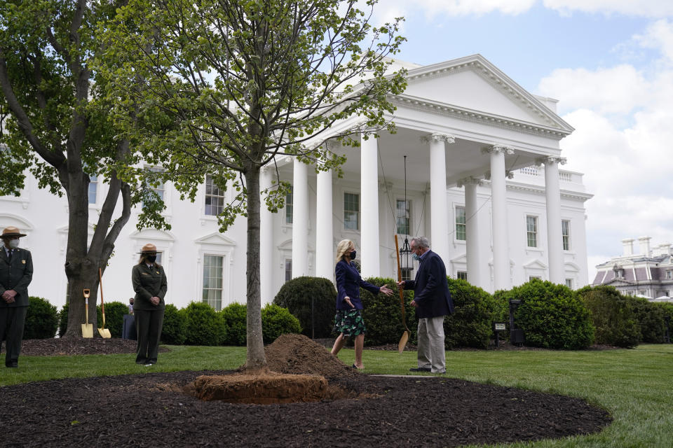 Superintendent of the White House Grounds Dale Haney hands first lady Jill Biden a shovel as she participates in an Arbor Day tree planting ceremony at the White House, Friday, April 30, 2021, in Washington. (AP Photo/Evan Vucci)