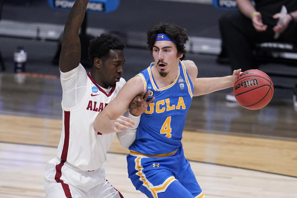 UCLA guard Jaime Jaquez Jr. (4) protects the ball from Alabama forward Juwan Gary (4) in the first half of a Sweet 16 game in the NCAA men's college basketball tournament at Hinkle Fieldhouse in Indianapolis, Sunday, March 28, 2021. (AP Photo/Michael Conroy)