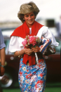 <p>This ensemble is so excellently put together it made us bow down in fashion respect. Note how it all matches, the flashes of red in the skirt and on the bag, to match the sweater so expertly. And then the clashing pink home made bouquet. We. Can't. Even. Deal.</p>