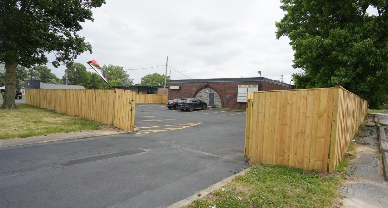 A fence surrounds the former library building on Columbus' Far South Side that is now become home to the Autonomy Project, which calls itself a "nonprofit dedicated to fostering respect and empowering personal autonomy at the vibrant intersection of the LGBTQIA+, sex work, and alternative lifestyle."