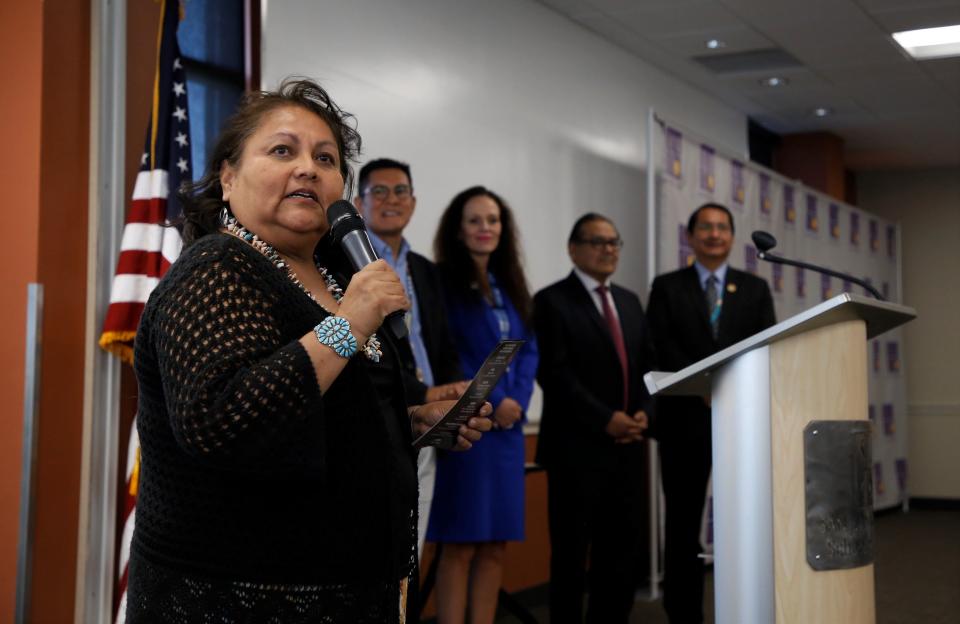 Navajo Technical University Enrollment Director Delores Becenti, left, introduces students who will graduate from NTU and received scholarships under the PNM Navajo Nation Workforce Training Initiative on May 10 at the San Juan College School of Energy in Farmington.