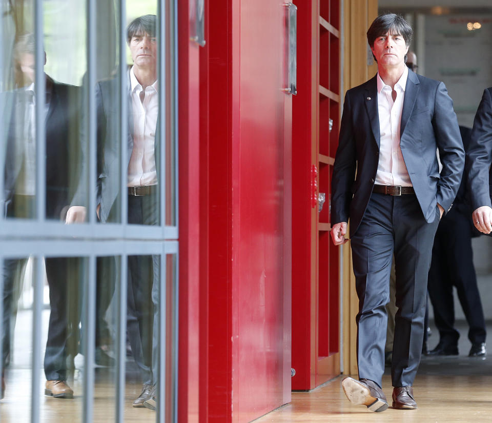 Coach of German national soccer team Joachim Loew is on his way to a press conference where he will present his preliminary team for the upcoming World Cup in Brazil in Frankfurt, Germany, Thursday, May 8, 2014. (AP Photo/Michael Probst)