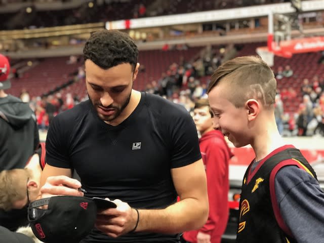 Larry Nance Jr. signs a cap for Evan Sherman — a Crohn's patient who attended the Athletes Vs. Crohn's and Colitis event in Chicago. (Courtesy of Katie Sherman)