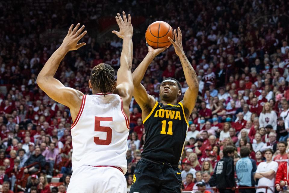 Feb 28, 2023; Bloomington, Indiana, USA; Iowa Hawkeyes guard Tony Perkins (11) shoots the ball while Indiana Hoosiers forward Malik Reneau (5) defends in the second half at Simon Skjodt Assembly Hall.