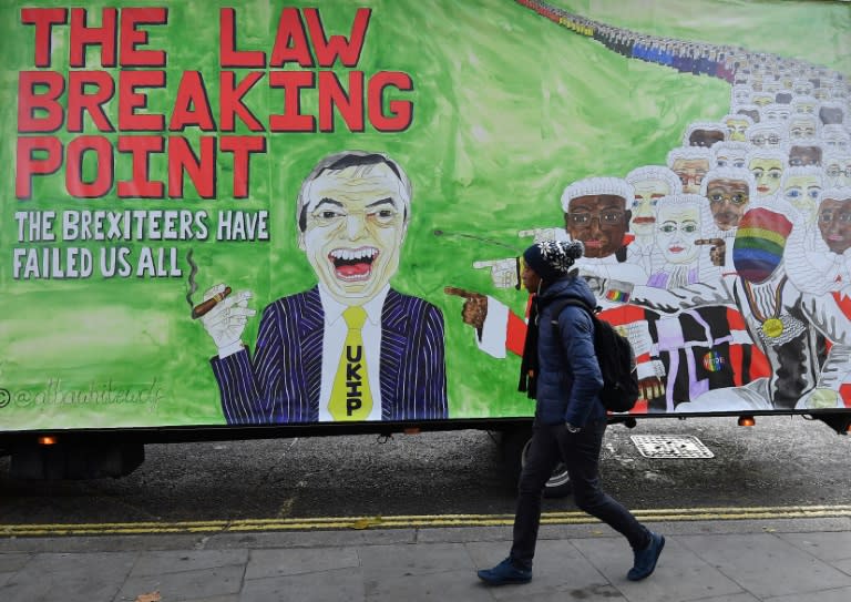 A man walks past a billboard in London depicting former UK Independence party leader Nigel Farage