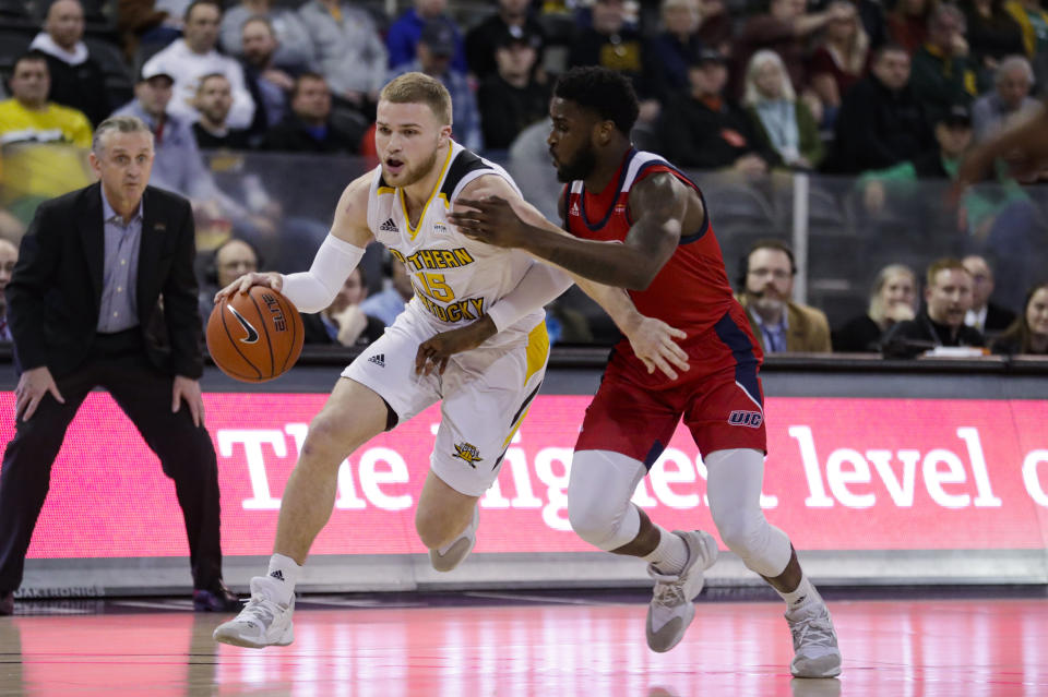 Northern Kentucky guard Tyler Sharpe (15) drives on Illinois-Chicago guard Marcus Ottey during the first half of an NCAA college basketball game for the Horizon League men's tournament championship in Indianapolis, Tuesday, March 10, 2020. (AP Photo/Michael Conroy)