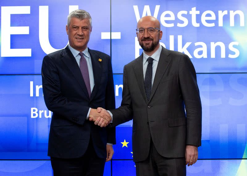 FILE PHOTO: Kosovo President Hashim Thaci (L) is greeted by European Council President Charles Michel at an EU-Western Balkans meeting in Brussels