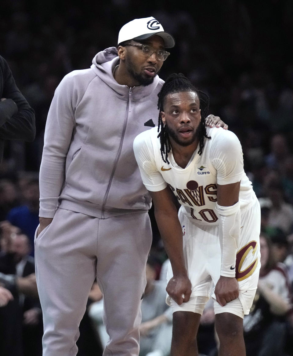 Cleveland Cavaliers' Donovan Mitchell, left, talks with Darius Garland during a timeout in the first half of Game 5 of the team's NBA basketball second-round playoff series against the Boston Celtics, Wednesday, May 15, 2024, in Boston. (AP Photo/Charles Krupa)