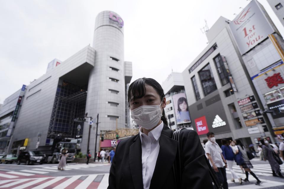 Hikari Tsunashima, poses for a photo in Tokyo Tuesday, July 21, 2020. Tsunashima, who is 21, says "I think people should wear as mask as much as they can. I think it will provide some precaution. It's too late once you are sick. So when you go outside, people should properly wear one (a mask) as precaution." (AP Photo/Eugene Hoshiko)