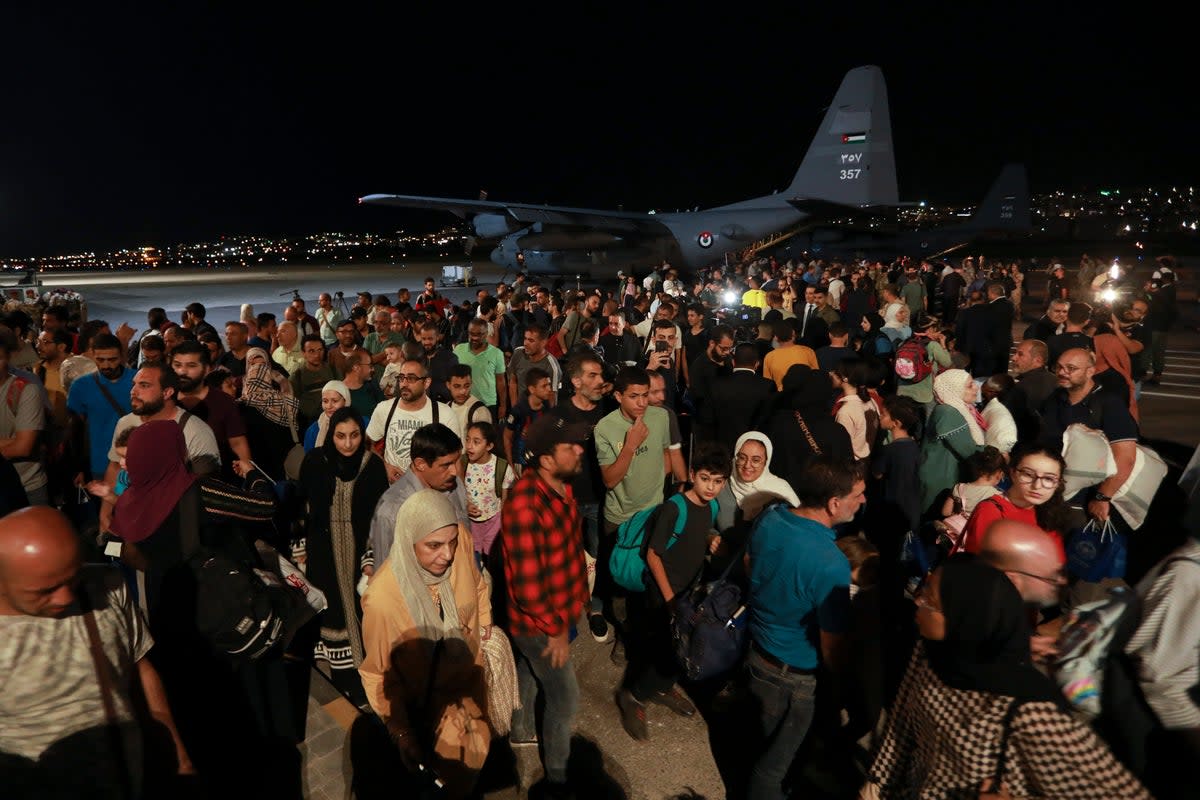 Jordanians evacuated from Sudan arrive at a military airport in Amman (AP)