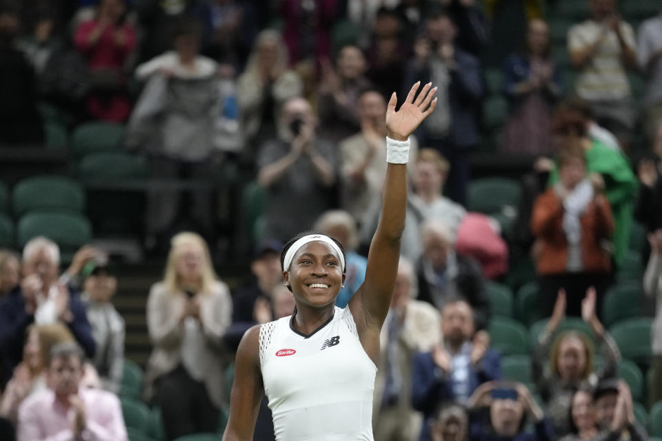 Coco Gauff of the US celebrates after beating Romania's Mihaela Buzarnescu in a second round women's singles match on day four of the Wimbledon tennis championships in London, Thursday, June 30, 2022. (AP Photo/Kirsty Wigglesworth)