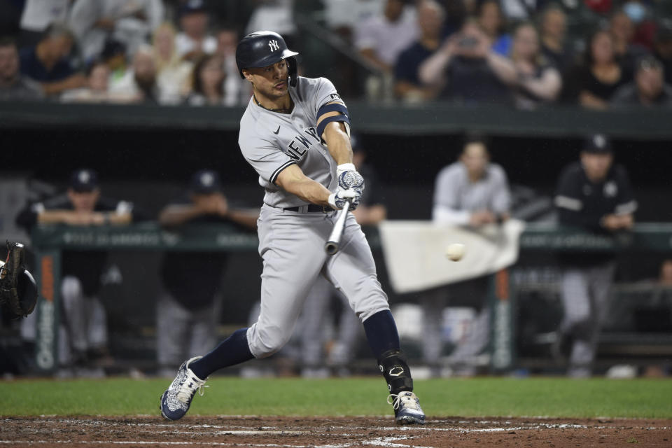 New York Yankees' Giancarlo Stanton hits a single against the Baltimore Orioles during the fifth inning of a baseball game Thursday, Sept. 16, 2021, in Baltimore. (AP Photo/Gail Burton)