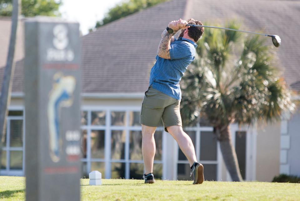 Geoff Holland tees off on the third hole at the Tiger Point Golf Club in Gulf Breeze on May 4, 2018.