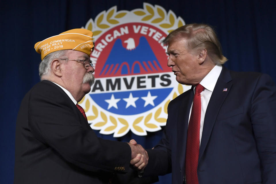 President Donald Trump greets AMVETS national commander Rege Riley at the American Veterans (AMVETS) 75th National Convention in Louisville, Ky., Wednesday, Aug. 21, 2019. (AP Photo/Susan Walsh)