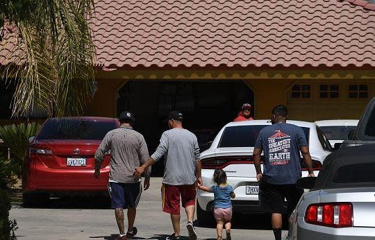 Relatives arrive at a Bakersfield home, where the last bodies were found in a shooting spree.