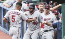 Jun 16, 2018; Cleveland, OH, USA; Minnesota Twins third baseman Eduardo Escobar (5) celebrates with catcher Bobby Wilson (46) after scoring during the first inning against the Cleveland Indians at Progressive Field. Mandatory Credit: Ken Blaze-USA TODAY Sports