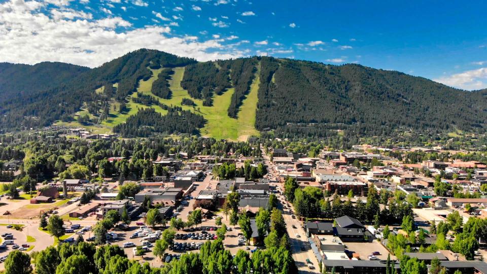 Panoramic aerial view of Jackson Hole homes and beautiful mountains on a summer morning, Wyoming.