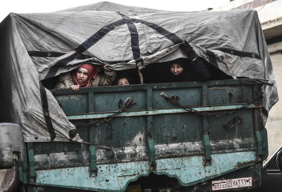 Civilians flee from Idlib toward the north to find safety inside Syria near the border with Turkey, Saturday, Feb. 15, 2020. Syrian troops are waging an offensive in the last rebel stronghold. (AP Photo)