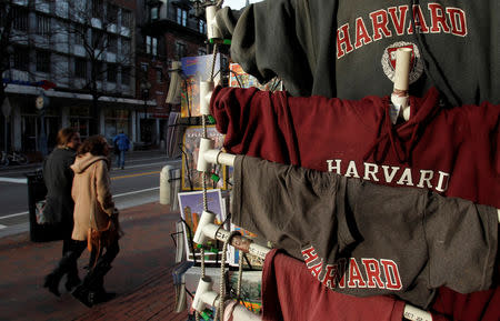 FILE PHOTO: People walk past Harvard University t-shirts for sale in Harvard Square in Cambridge, Massachusetts, U.S., November 16, 2012. REUTERS/Jessica Rinaldi/File Photo