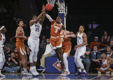 Apr 2, 2019; New York, NY, USA; Texas Christian Horned Frogs center Kevin Samuel (21) and Texas Longhorns guard Courtney Ramey (3) fight for a loose ball in the first half of the NIT semifinals at Madison Square Garden. Mandatory Credit: Wendell Cruz-USA TODAY Sports