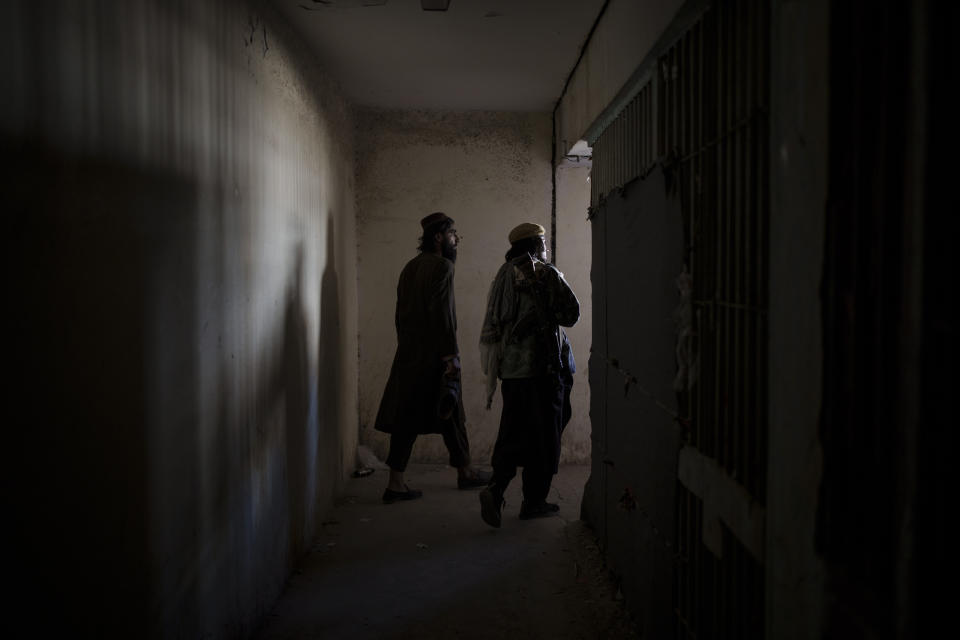 Taliban fighters walks inside an abandoned area of the Pul-e-Charkhi prison in Kabul, Afghanistan, Monday, Sept. 13, 2021. When the Taliban took control of a northern Afghan city of Pul-e-Kumri the operator of the only women's shelter ran away, abandoning 20 women in it. When the Taliban arrived at the shelter the women were given two choices: Return to their abusive families, or go with the Taliban, With nowhere to put the women, the Taliban took them to the abandoned women's section of Afghanistan's notorious Pul-e-Charkhi prison. (AP Photo/Felipe Dana)