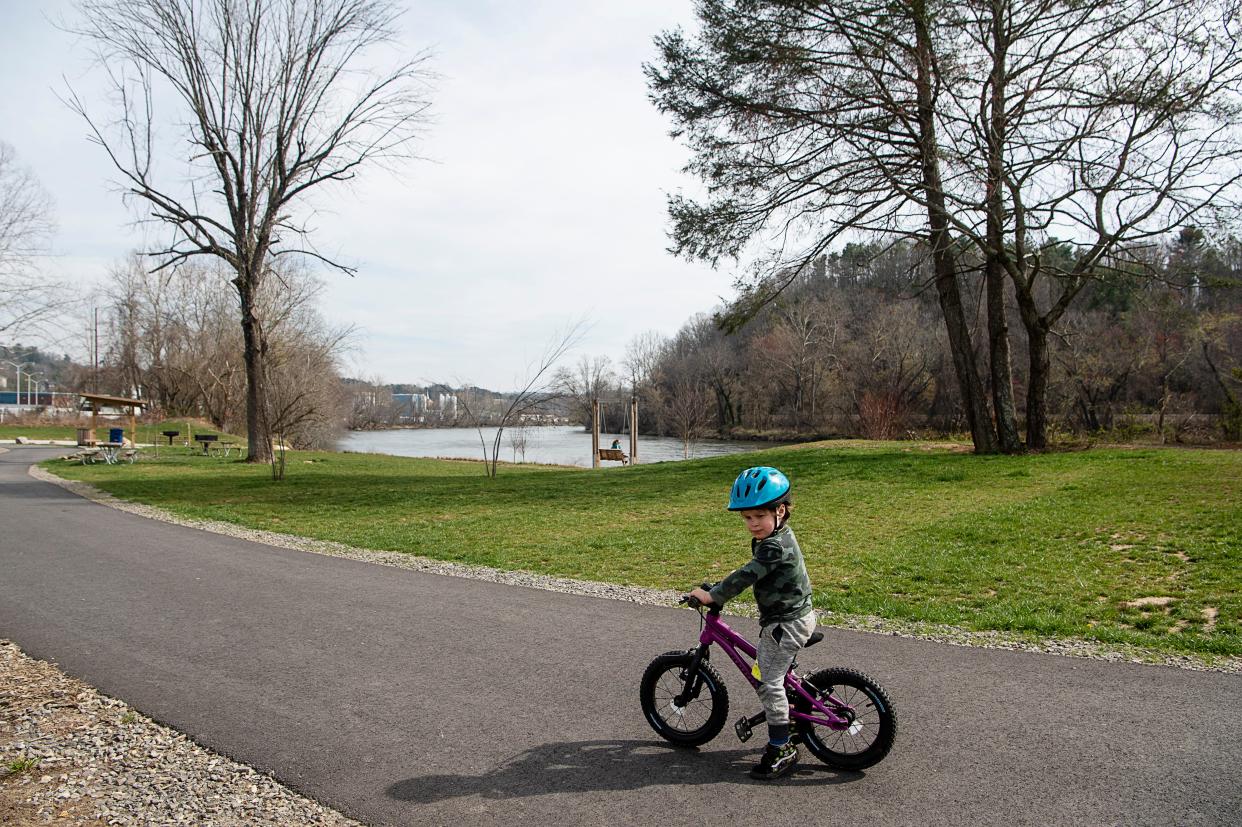 Ames Peterson, 3, rides his bike at Silver-Line Park in Woodfin March 16, 2023. There are two sections of the Woodfin Greenway planned, one along Riverside Drive and the other along Beaverdam Creek. The greenway would pass through the park.