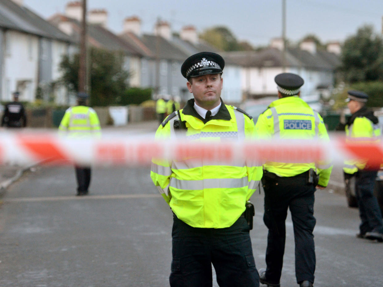 Police officers closed off a street in the Sunbury-on-Thames area, where Ahmed Hassan lived: PA