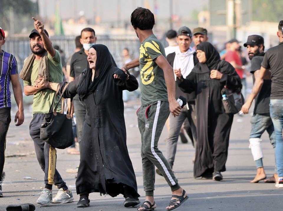 An Injured protester walks towards Tahrir square to join anti-government protesters in central Baghdad, Iraq, Thursday, Oct. 3, 2019. Iraqi security forces fired live bullets and used tear gas against a few hundred protesters gathered in central Baghdad on Thursday, hours after a curfew was announced in the Iraqi capital. (AP Photo/Hadi Mizban)