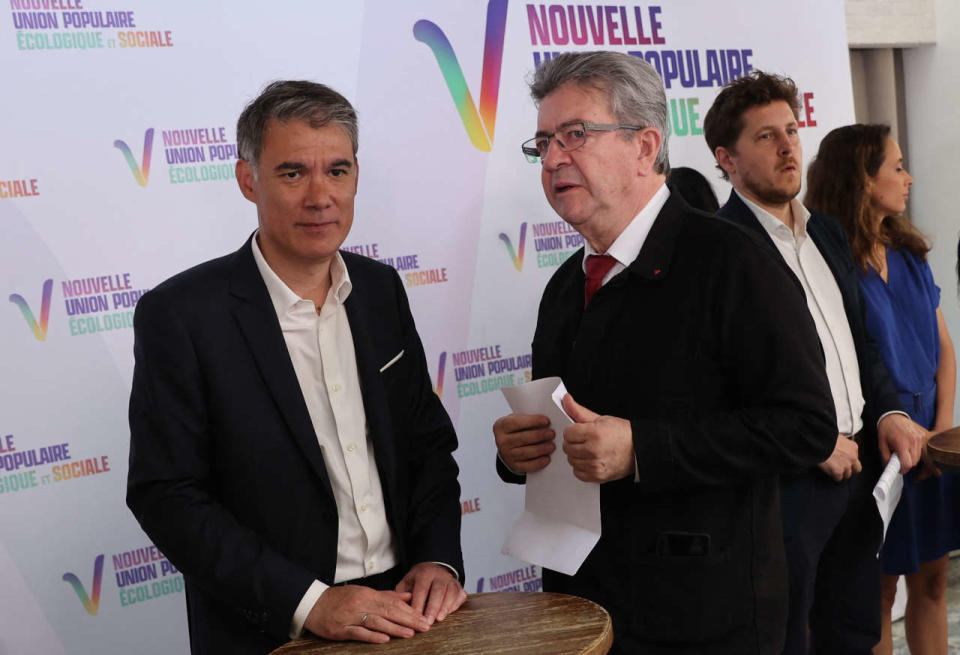 French leftist party La France Insoumise (LFI) leader Jean-Luc Melenchon (R) speaks with Socialist Party politician Olivier Faure at a press conference in Paris on May 19, 2022, held to present the programme of left wing coalition Nouvelle Union Populaire Écologique et Sociale (NUPES) ahead of France's parliamentary election. (Photo by Thomas SAMSON / AFP)