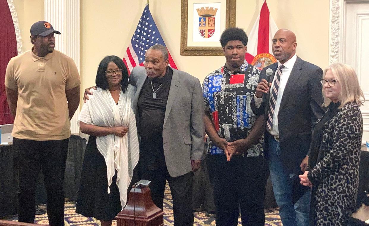 Wayne Fields hugs his wife Linda in between their sons Jerald and T'Andre Fields during a presentation by the St. Augustine City Commission recognizing Wayne Fields' father, the late Dr. Julius Gazelle Fields, in honor of National Dentist Day in February. Standing with the Fields are Dr. Fields' cousin Derek Hankerson and city Vice Mayor Nancy Sikes-Klien. Dr. Fields was a community leader and dentist for practiced in the city from 1951 until he died in 1967. 