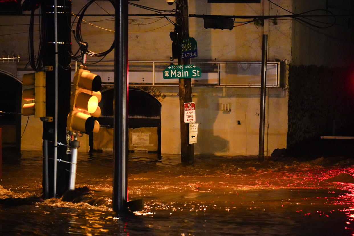 Flooding rose halfway to a street sign in the Manayunk section of Philadelphia on Thursday.