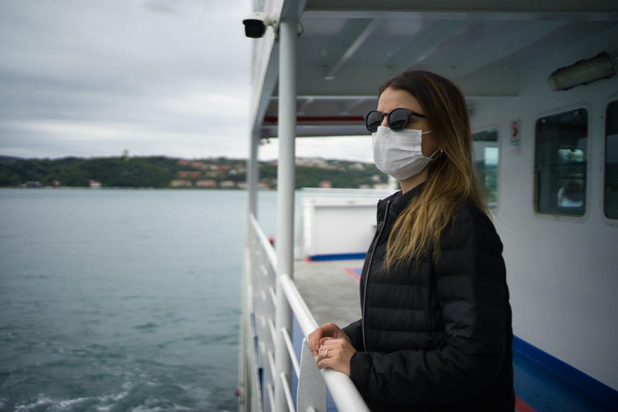 Woman with protective face mask on the ferry