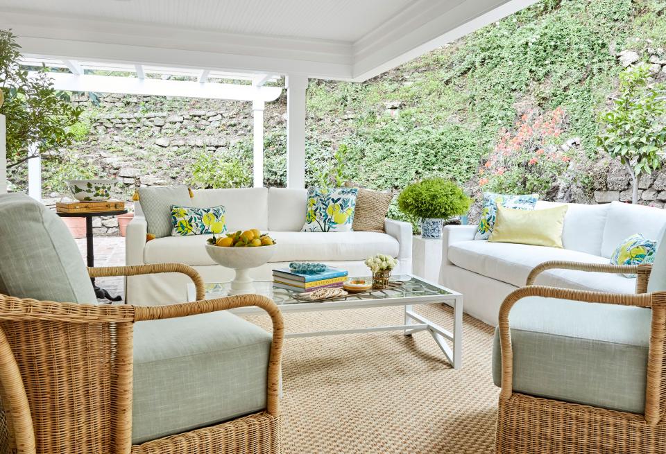 The outdoor living room when they moved in was “as different as you could imagine,” says Nicolas. But after reimagining the space and adding slipcovered RH sofas and Schumacher pillows, it’s become a favorite and oft-used hangout.