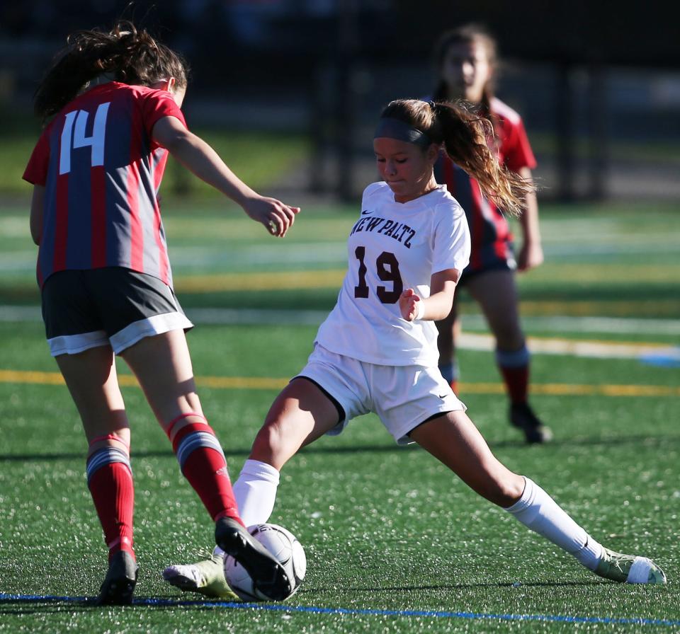 New Paltz's Leah Schamberg slides in on Red Hook's Kaitlin Murphy during the Section 9 Class A girls soccer semifinal on October 28, 2021. 