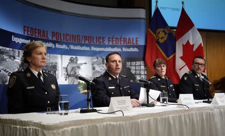 (L to R) Assistant Superintendent Joan McKenna, Ottawa Police Services; Assistant Commissioner James Malizia, RCMP Federal Policing Operations; Chief Superintendent Jennifer Strachan, RCMP Criminal Operations Office, and Deputy Commissioner Scott Tod, Ontario Provincial Police, listen to reporters' questions at RCMP headquarters after announcing terror-related charges have been laid against three men in Ottawa, February 3, 2015. REUTERS/Patrick Doyle