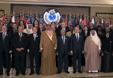 U.N. Secretary-General Ban Ki-moon (3rd L) stands with Kuwait Minister of Foreign Affairs and Deputy Prime Minister Sheikh Sabah al-Khaled al-Sabah (4th left) for a photo ahead of the Third International Humanitarian Pledging Conference for Syria in Bayan Palace March 31, 2015. REUTERS/Stephanie McGehee