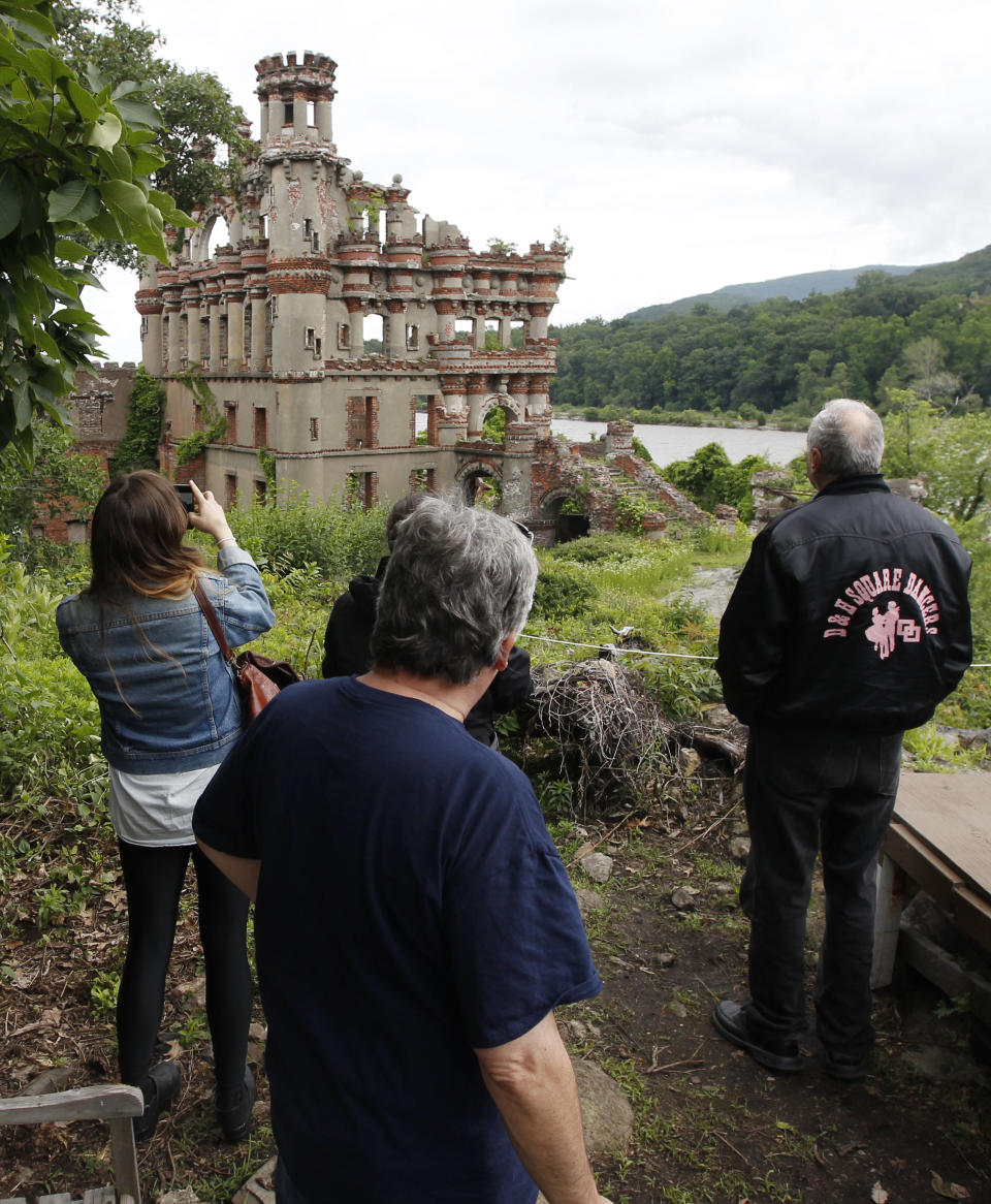 Media and tourism officials photograph Bannerman's Island Arsenal  on Pollepel Island, N.Y., on Tuesday, June 5, 2012. Though it looks like it was built to withstand battering rams, it was actually a surplus military goods warehouse made to resemble a Scottish castle. Businessman Francis Bannerman VI had it built early in the 20th century as a place to store helmets, haversacks, mess kits and munitions he could not store in his thriving shop in Manhattan. (AP Photo/Mike Groll)