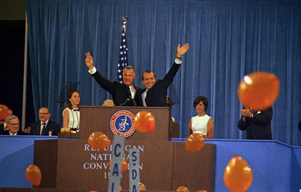 Richard Nixon, right, and his running mate, Spiro Agnew, wave to supporters at the Republican National Convention in Miami in 1968. (Photo: AP)